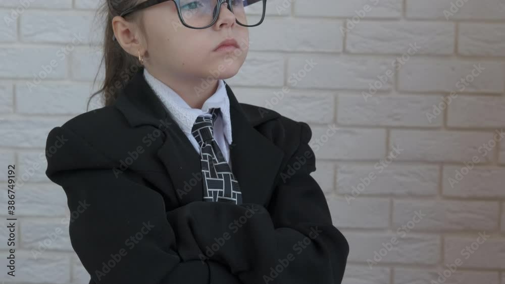 Girl engaged in office work. A view of a smart little boss in the suit. Girl engaged in office work. A view of a smart little boss in the suit.