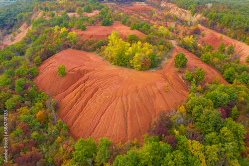 Gant, Hungary - Aerial view of abandoned bauxite mine, bauxite formation, the red mountains resembling Martian landscape. Red and orange colored surface, bauxite texture with warm autumn colors