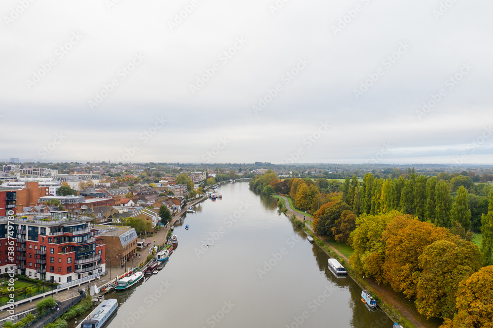 Aerial Landscape View Over a River in the Middle of a Town and a Forest