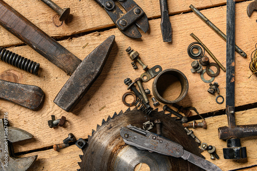 Variety of old vintage household hand tools still life on a wooden background in a DIY and repair concept