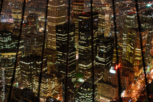 Photography Downtown financial district highrise towers behind bars at night