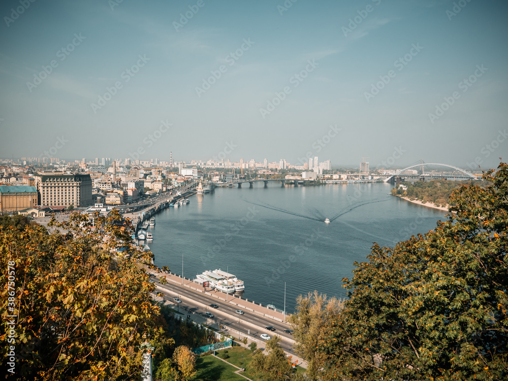Fototapeta premium Kyiv, Ukraine - October 10th 2020: Cityscape of Podol district in Kyiv city. Kontraktova square, Kiev Mohyla Academy and Ferris wheel