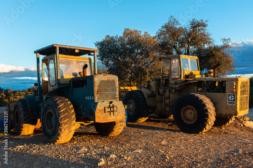 Old tractors with sunset light reflection