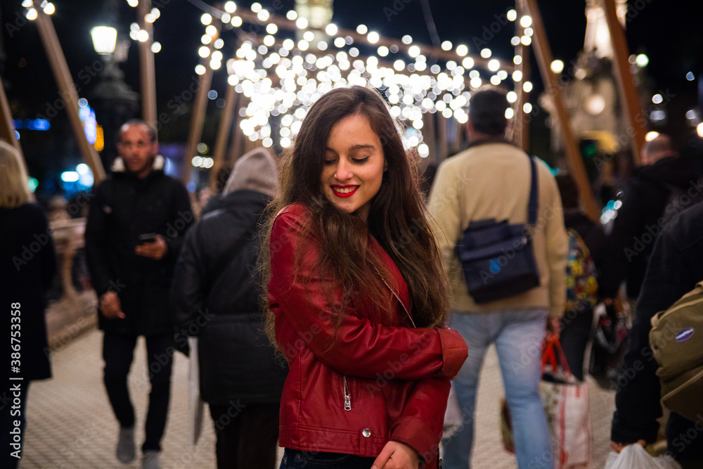 Girl going for a walk through Donostia-San Sebastian with the illuminations for Christmas.