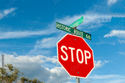 Red stop road sign with Historic Route 66 above photo