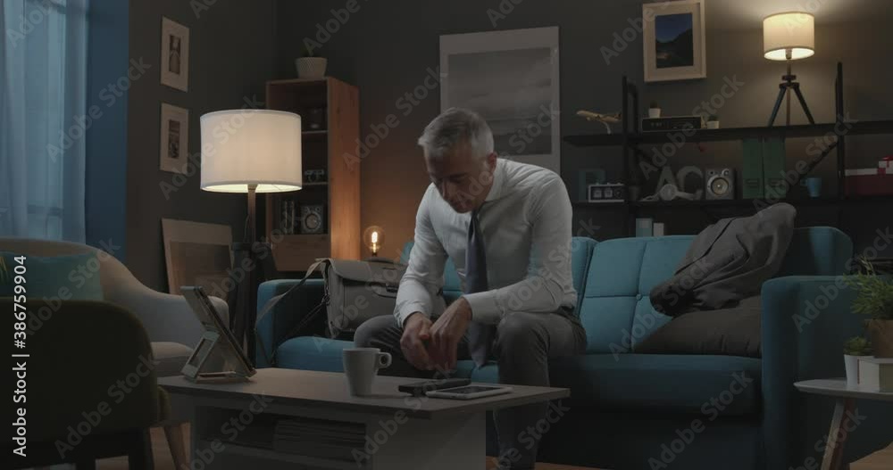 Businessman coming back home from work at night