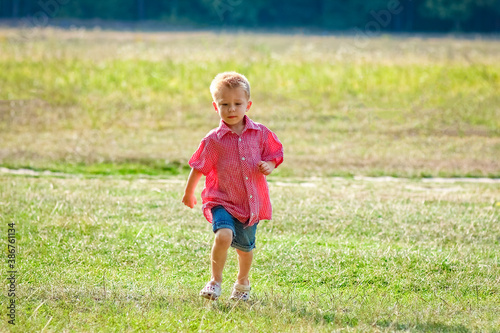 A Happy child playing in nature in summer