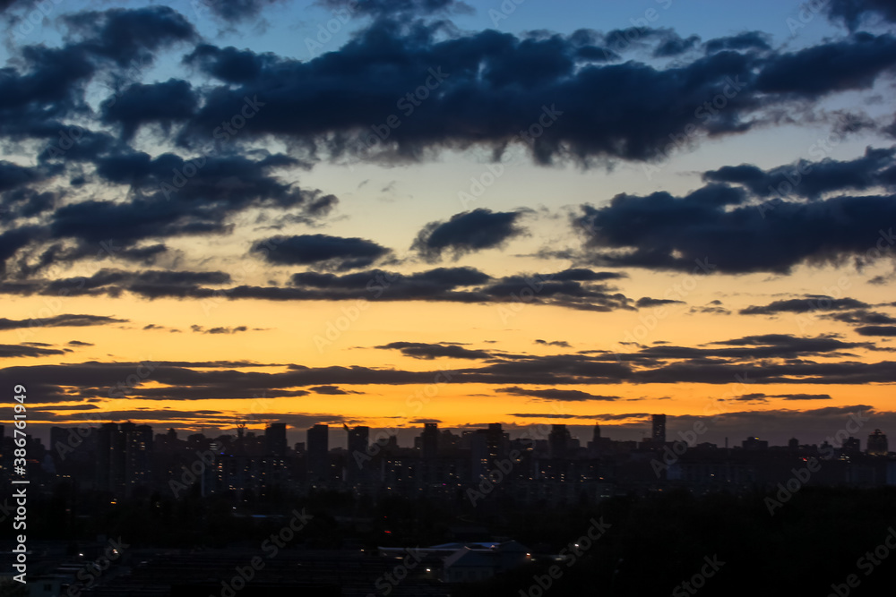 Beautiful sunset and clouds in the sunset orange and blue sky, big city view