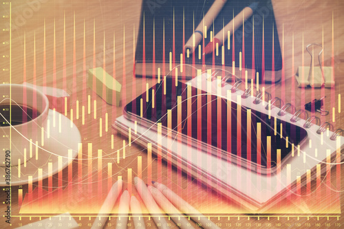 Double exposure of forex chart drawing and cell phone background. Concept of financial trading