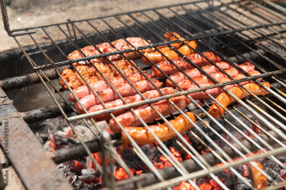 Grilled sausage on barbecue, grill. Shallow depth of field.