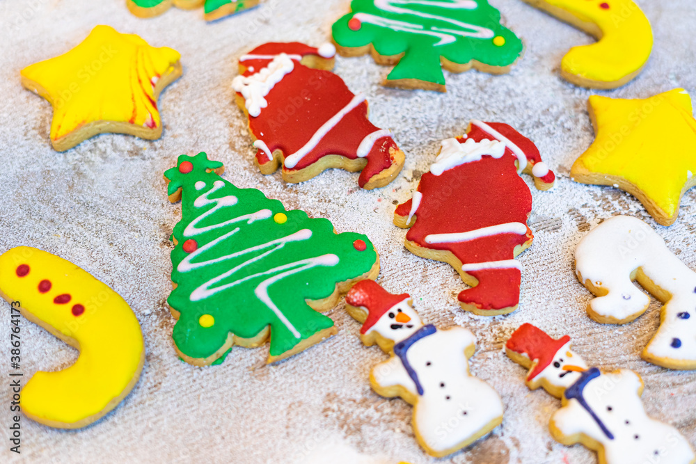 colorful Christmas homemade gingerbread cookies with snow background
