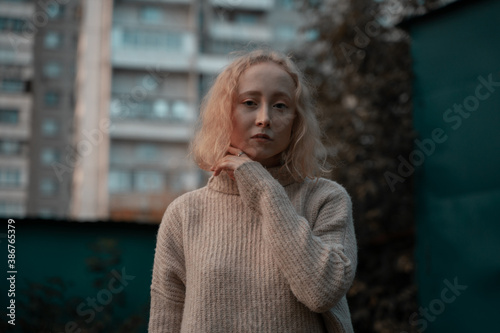 Portrait of a young girl on the background of a residential building photo