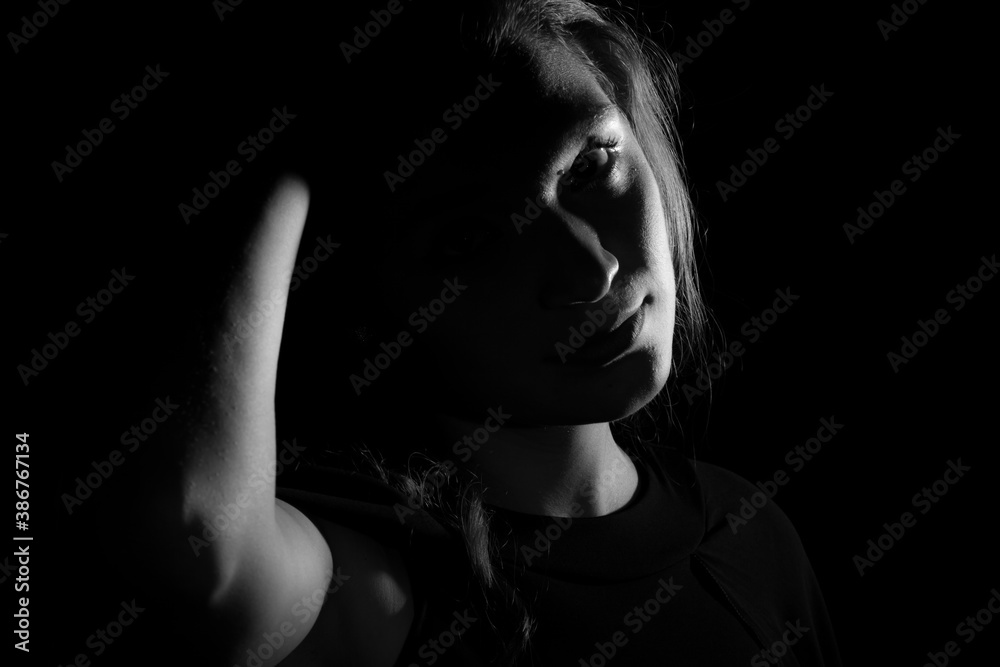 Black and white portrait of an Italian young woman on black background