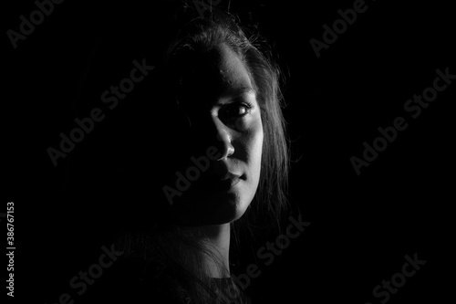 Картината върху платно Black and white portrait of an Italian young woman on black background