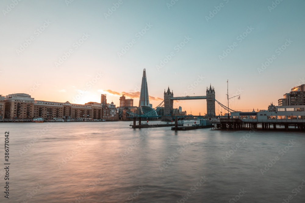London Tower Bridge and skyline at sunset - Beautiful view of London with Thames river on foreground and famous landmarks in the centre of the frame - travel and architecture