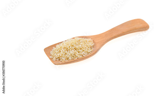 Sesame seeds in a wooden spoonl isolated on white background