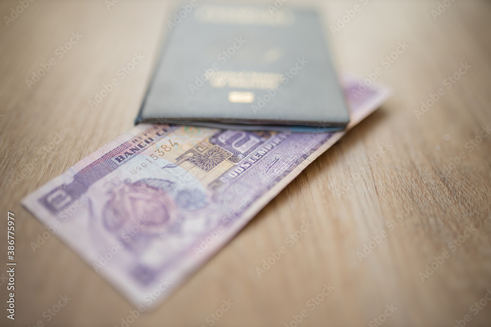 Central Bank of Honduras on a Two Lempiras Bill Inside an American Passport Central Bank of Honduras on a Two Lempiras Bill Inside an American Passport