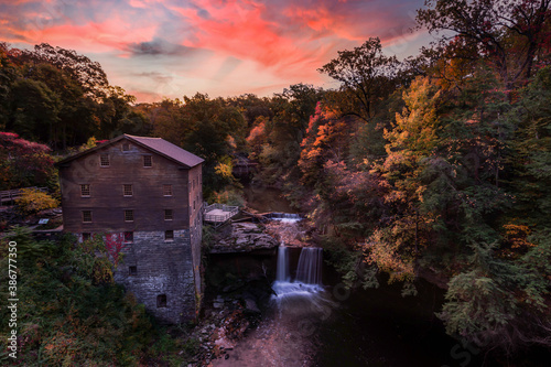 Sunrise moment in autumn season.Colorful of nature at Lanterman Mill Yountown Ohio.Very nice landscape with waterfall and river. Long exposure shutter and selective focus.  photo