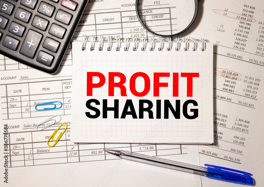 Office desk with a paper written PROFIT SHARING Office desk with a paper written PROFIT SHARING