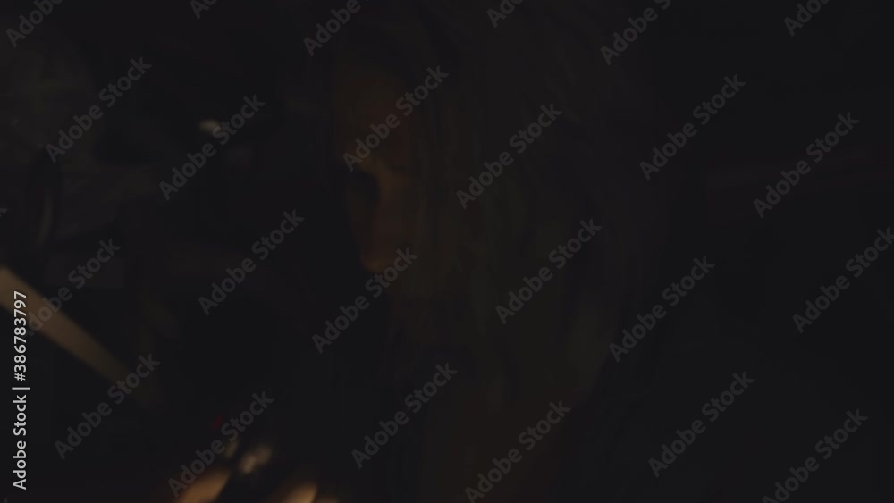 Woman with flashlight in dark shelter talking on walkie-talkie Woman with flashlight in dark shelter talking on walkie-talkie