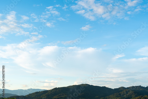 The white clouds have a strange shape and moutain.