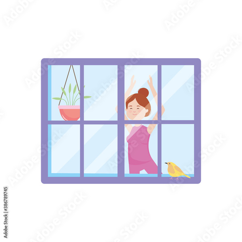 view through the window of a woman practicing yoga at home activity indoor