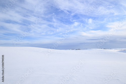 Cold Cirrus Clouds in an otherwise Blue Sky over a Snow Covered Countryside in the Palouse of Eastern Washington State, USA
