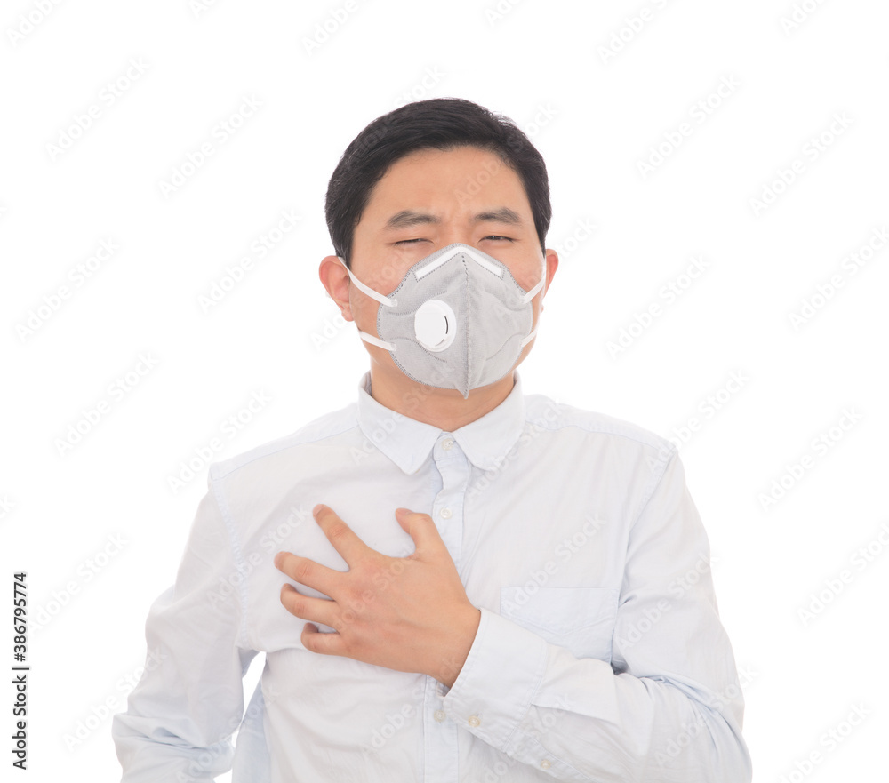 Man wearing a mask feels uncomfortable when he touches his lungs
