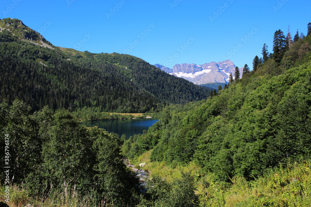A clear blue lake with a special ecology located in the mountains and surrounded by forest. Caucasus, lake Kardyvach A clear blue lake with a special ecology located in the mountains and surrounded by forest. Caucasus, lake Kardyvach