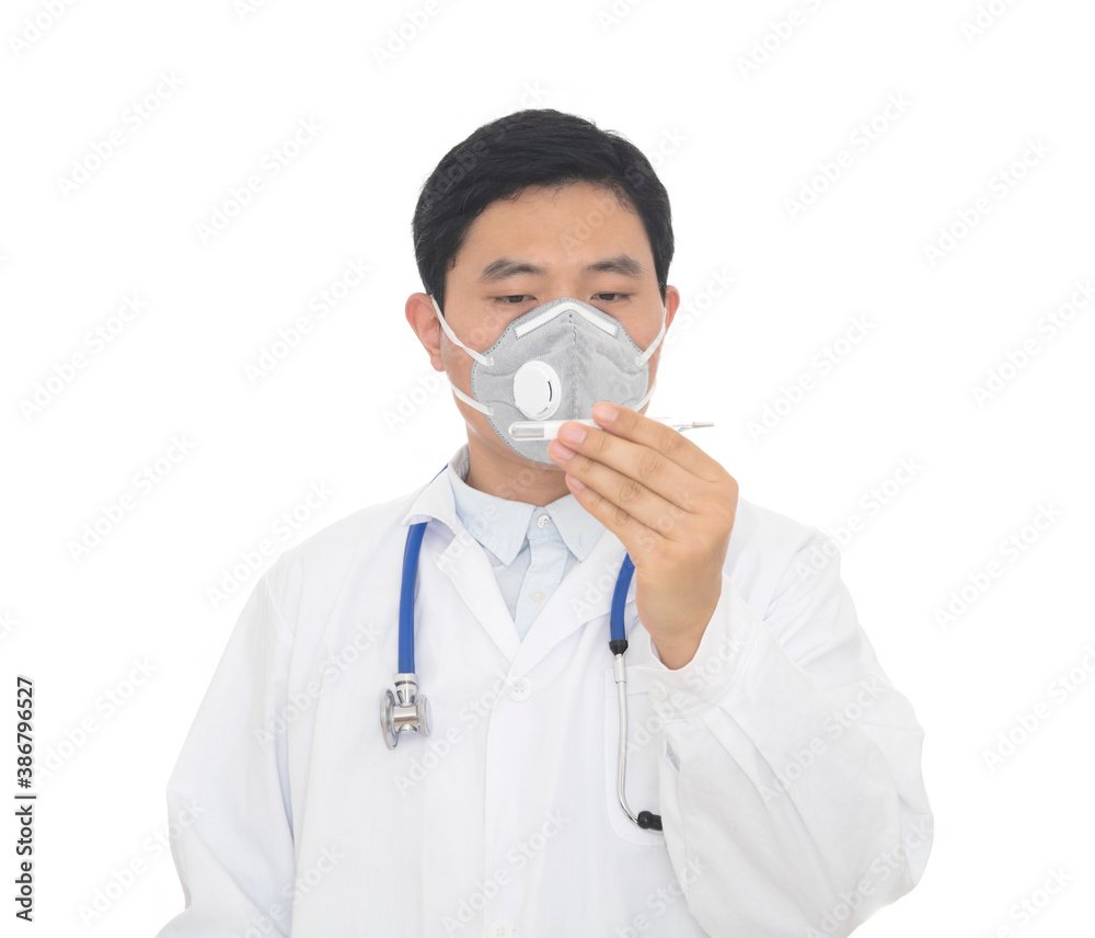 A male doctor wearing a mask in the hospital checks a thermometer