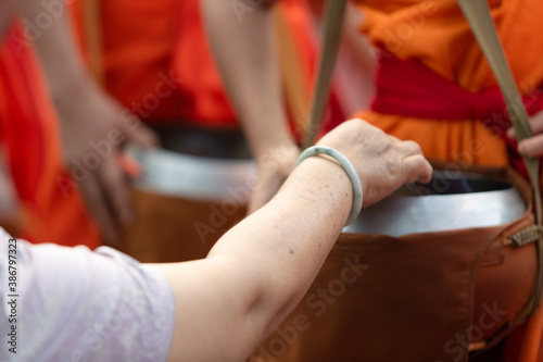 Buddhist monks on everyday morning traditional alms giving in Luang Prabang  Laos.