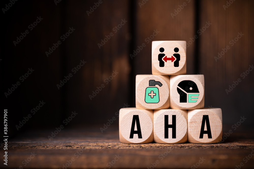 German acronym AHA for the three rules in a pandemic DISTANCE, HYGIENE, FACE MASKS in front of wooden background - obrazy, fototapety, plakaty 