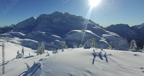 Zoom out pan shoot to helicopter 
Top of Glacier mountain in Tofino British Colombia. Winter with snow in vancuver photo