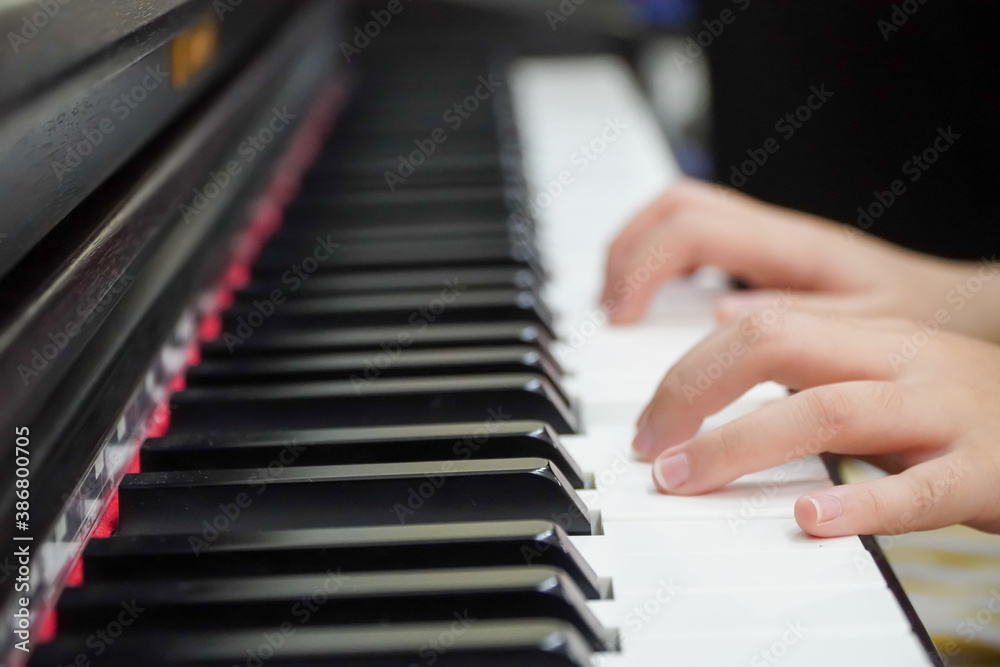 close-up of a happy girl's hand playing the piano in the morning. close-up of a happy girl's hand playing the piano in the morning.