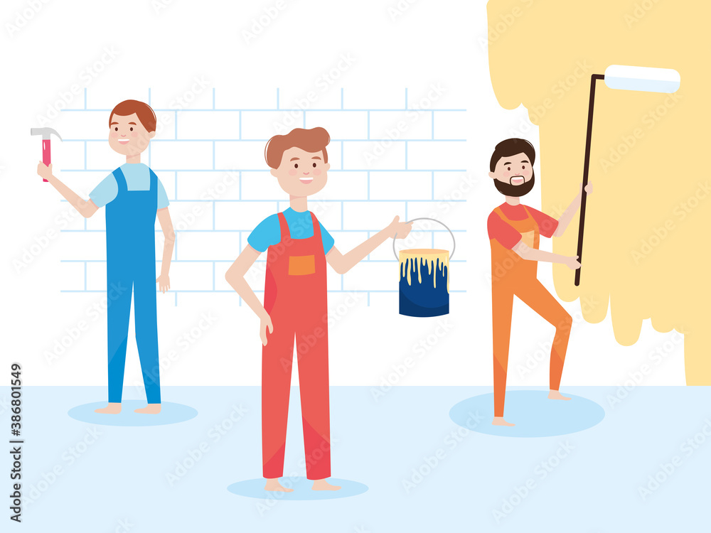 Obraz premium team workers wall remodeling with paint roller, bucket and hammer remodeling