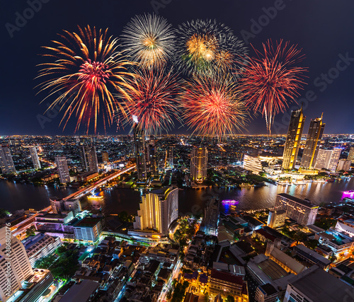 Fireworks celebrating over Chao Phraya river in Bangkok city at night, Thailand © geargodz