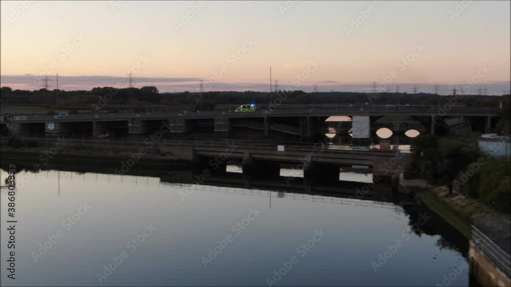 Aerial drone shot at sunset leads to ambulance blue lights over the bridge Aerial drone shot at sunset leads to ambulance blue lights over the bridge