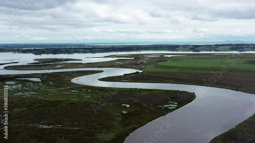 AERIAL Truck Left Over Lake Estuary Spilling Out To A Winding River photo