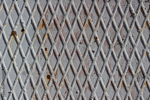 Rusty metal surface texture with diamond patterns. Background