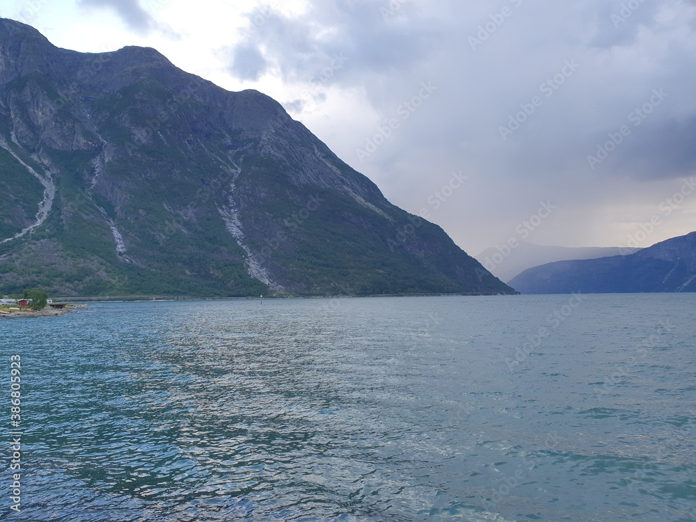 landscape with mountains against the backdrop of a blue fjord - Eidfjord
