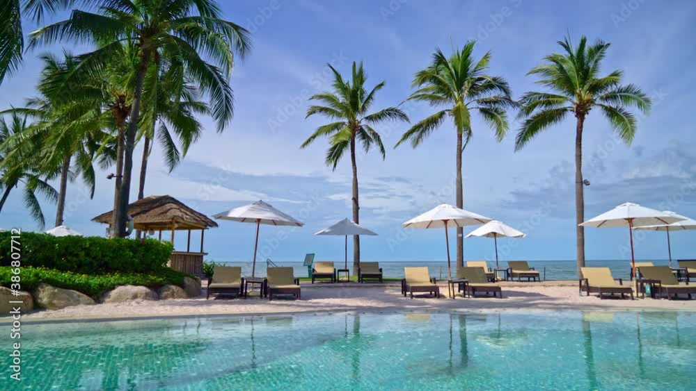 Beautiful umbrella and chair around swimming pool in hotel and resort - vacation concept Beautiful umbrella and chair around swimming pool in hotel and resort - vacation concept