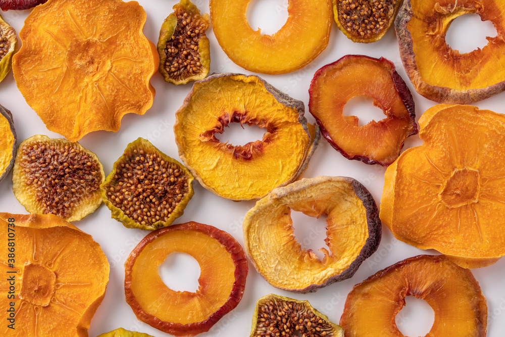 slices of dried persimmon, peach, plum and figs on a white background. dried fruits. eco. slices of dried persimmon, peach, plum and figs on a white background. dried fruits. eco.