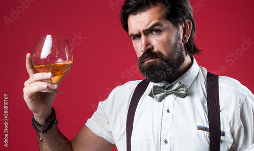 serious mature man drinking whiskey from glass, restaurant
