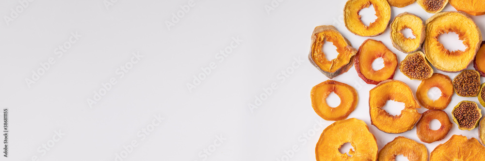 slices of dried persimmon, peach, plum and figs on a white background. dried fruits. eco. slices of dried persimmon, peach, plum and figs on a white background. dried fruits. eco.