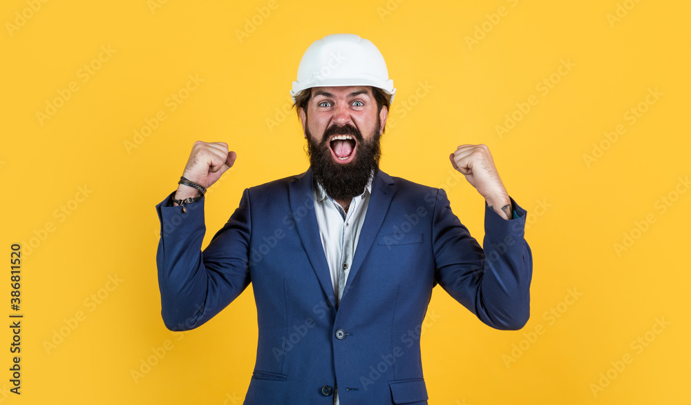 happy shouting businessman in hard hat celebrating success, happiness
