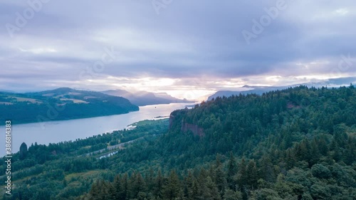 Aerial dronelapse hyperlapse of breathtaking and spectacular nature sunrise in the Columbia River Gorge with Vista House at the Crown Point situated on the edge of a steep rock. photo