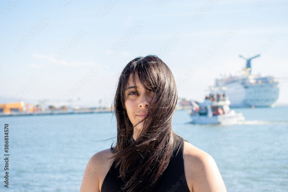 portrait of beautiful mexican woman smiling in sea port