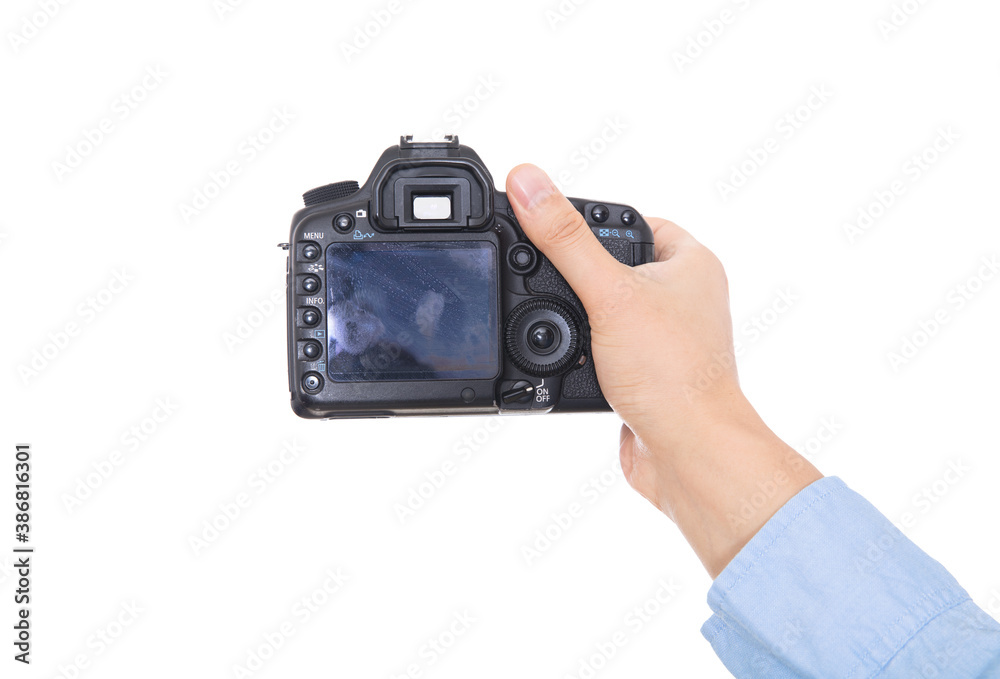 Hand holding black SLR camera close-up