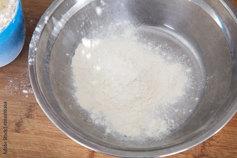 White flour in a steel basin White flour in a steel basin