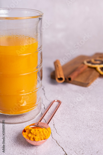 selective focus. honey cake with delicate cream. on a light background with craft paper. in the background is a jar of light honey photo